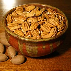 Bowls of raw local walnuts and pecans